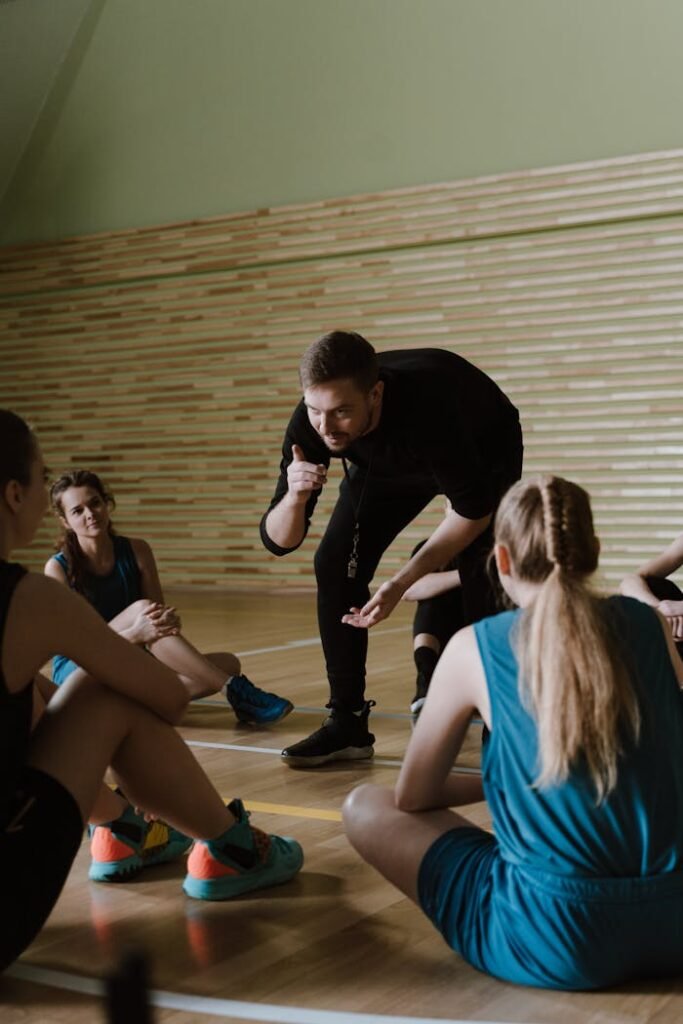 A Man Coaching a Women's Basketball Team